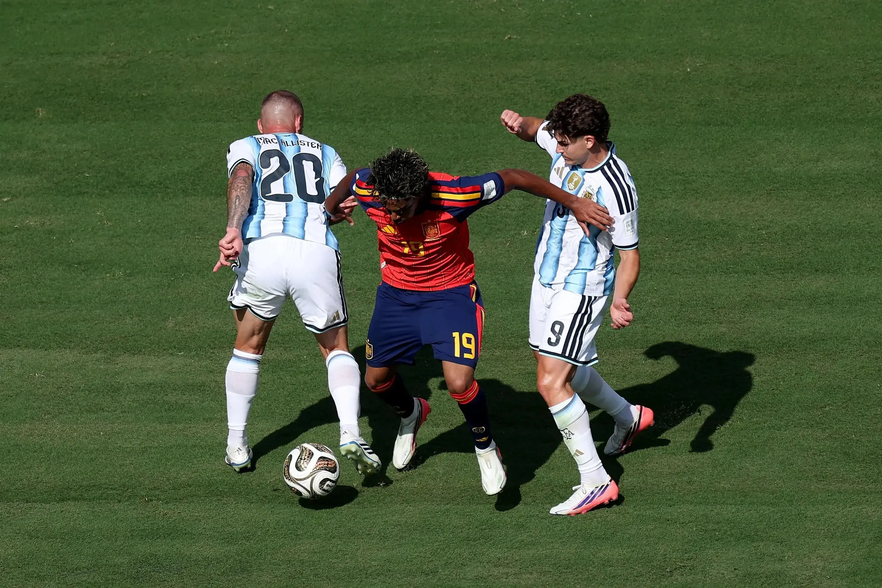 EAST RUTHERFORD, NEW JERSEY - JULY 19: Lamine Yamal #19 of Spain competes for the ball against Alexis Mac Allister #20 and Julian Alvarez #9 of Argentina during the FIFA World Cup 2026 Final match between Spain and Argentina at New York New Jersey Stadium on July 19, 2026 in East Rutherford, New Jersey. (Photo by Kevin C. Cox/Getty Images)